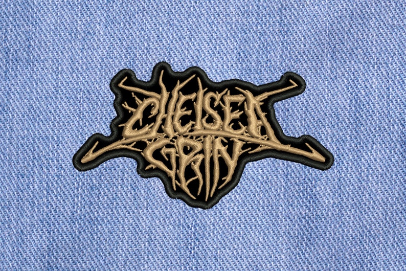 May include: Black and gold embroidered patch with the text "Chelsea Grin" in a stylized font.