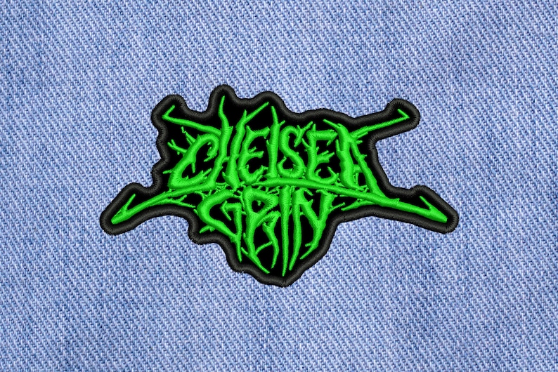May include: Green embroidered patch with the words "Chelsea Grin" in a stylized font.