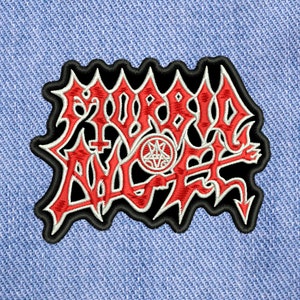 May include: Black and red embroidered patch with the words "SODOM ANGEL" in a stylized font. The patch features a pentagram with a cross inside.