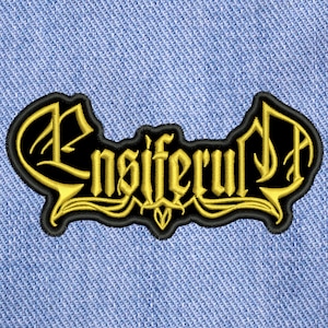 Puede incluir: Parche bordado en negro y dorado con la palabra "Ensiferum" en una fuente estilizada.