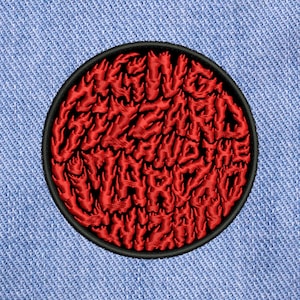 May include: Red embroidered patch with the text "King Gizzard and the Lizard Wizard" in a flame-like font. The patch is circular and has a black border.