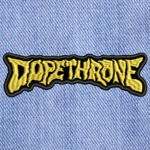 May include: A black and yellow embroidered patch with the text "DOPETHRONE" in a stylised font.