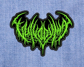 May include: Green embroidered patch with a black background. The patch features a stylized, dripping font that reads "EVILDEAD".