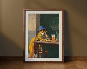 May include: Framed art print featuring a cheetah wearing sunglasses and a blue bucket hat, sitting at a table with a beer. The cheetah is draped with a yellow scarf. The print is in a brown wooden frame.