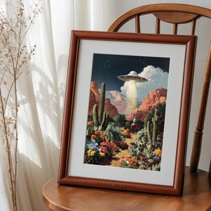Retro cowboy UFO poster framed on a wooden chair near a sunlit curtain, rustic farmhouse western vibe.