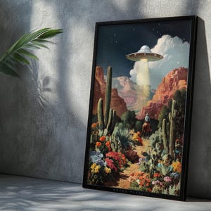 Flying saucer desert poster leaning on a concrete wall with cactus shadows, rustic-modern Western atmosphere.