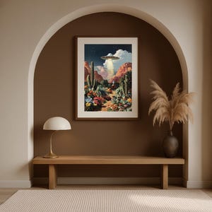 Southwestern UFO cowboy wall art framed inside an arched alcove with pampas grass and warm earthy tones.