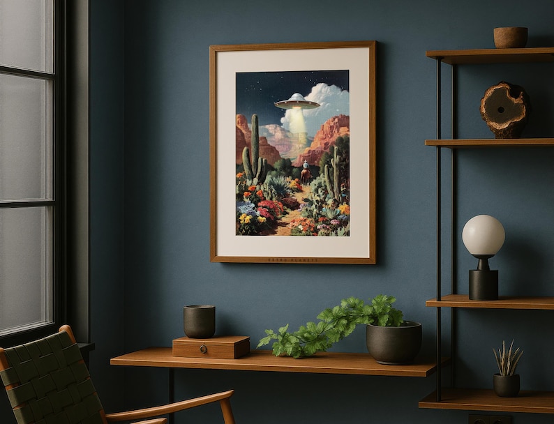 UFO desert cowboy poster framed on a navy wall above a modern wooden desk with plants, eclectic and quirky vibe.