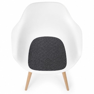 May include: White modern armchair with a curved back and a dark gray seat cushion. The chair has four wooden legs. The design is minimalist and contemporary, suitable for living rooms or offices.