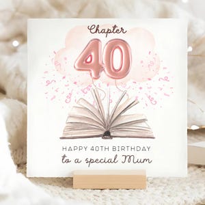 May include: A square birthday card with the text "Chapter 40" and "Happy 40th Birthday to a special Mum." The card features a watercolor illustration of a book, pink confetti, and a pink balloon shaped like the number 40.