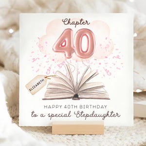 May include: A birthday card with a watercolor design. The card features a pink balloon shaped like the number 40, a cloud, confetti, and an open book. The text reads "Chapter 40" and "Happy 40th Birthday to a special Stepdaughter."