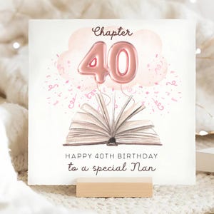 May include: A birthday card with the text "Chapter 40" and "Happy 40th Birthday to a special Nan." The card features a watercolor illustration of a book with the number 40 as a balloon, and pink confetti.