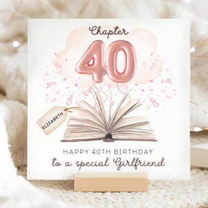May include: A birthday card with a watercolor design. The card features a pink balloon shaped like the number 40, a cloud, confetti, and an open book. The text reads "Happy 40th Birthday to a special Girlfriend" and "Chapter 40". A tag reads "Elizabeth".