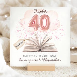 May include: A birthday card with a watercolor illustration. The card features a pink balloon shaped like the number 40, a book, and the text "Happy 40th Birthday to a special Stepsister". A tag with the name "Elizabeth" is also included.