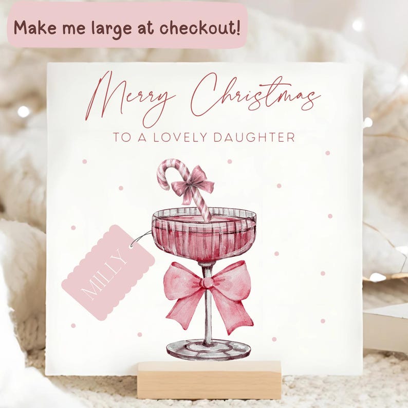 May include: A Christmas card with a watercolor illustration of a pink cocktail glass with a candy cane and bow. The card reads "Merry Christmas To A Lovely Daughter" and includes a tag that says "Milly".