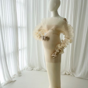 Full-length side profile of the Celessia gown on a mannequin, emphasizing the flow and length of the skirt, designed to catch the wind for dramatic "flying dress" outdoor maternity portraits.