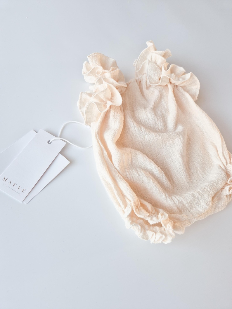 Versatile studio foundation piece. Vanilla off-white baby girl clothes in premium breathable cotton. Comfortable, high-stretch design for calm newborn outfit changes during memorable hospital announcement photography sessions.