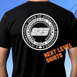 May include: A black t-shirt featuring a white circular logo on the back. The logo reads International Union of Operating Engineers, Organized Dec. 7, 1896, Labor Omnia Vincit, and the number 825. The text NEXT LEVEL SHIRTS appears in orange.