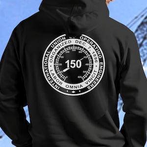 May include: Black hooded sweatshirt with a white circular graphic on the back. The graphic features the text "INTERNATIONAL LABOR UNION ORGANIZED DEC. 7, 1896 OPERATING ENGINEERS" and the number "150".