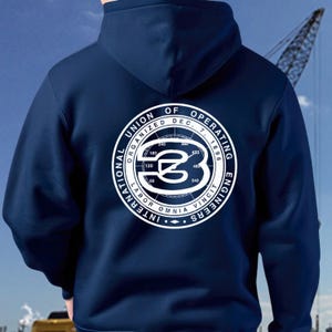May include: Navy blue hoodie featuring a white circular graphic on the back. The graphic includes the text "INTERNATIONAL UNION OF OPERATING ENGINEERS" and a stylized "B" inside a circle with degree markings. The hoodie has a hood.