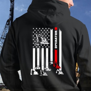 May include: Black hoodie with a white and red American flag design. The flag has an excavator graphic and the word "OPERATOR" printed on the right side.