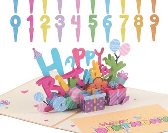 May include: A colorful birthday card with a pop-up design and the words "Happy Birthday." Includes a set of number cake toppers in various colors. The card features gift boxes and balloons.
