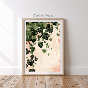 May include: A digital art print featuring a green leafy vine with heart-shaped leaves hanging down against a peach-colored background with white and pink splatter paint.