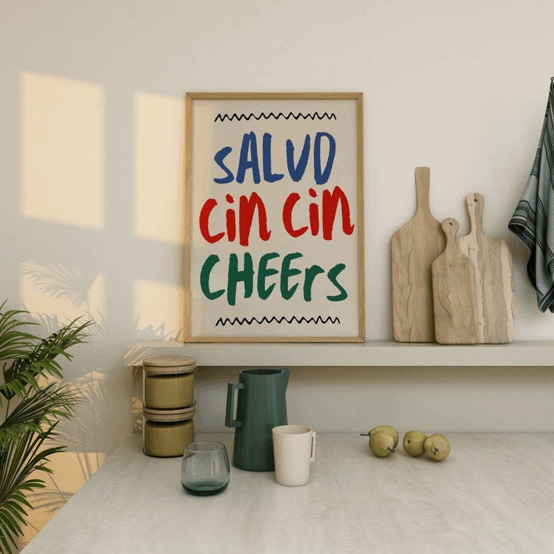 May include: A white ceramic mug with a black handle and the text "But First, Coffee" in a bold, black font. The mug is set against a blurred background, suggesting a cozy setting.