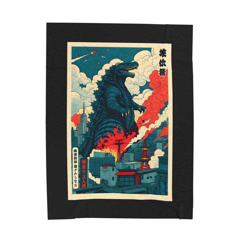 A black blanket featuring a Godzilla-themed design. The artwork depicts Godzilla in a city setting with red and blue hues, reminiscent of a vintage Japanese poster. The blanket is rectangular and placed on a bed.