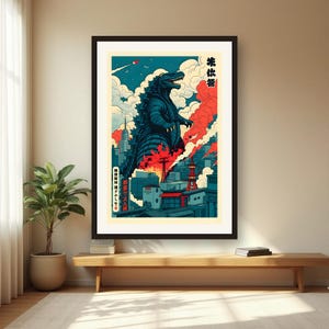 May include: A framed poster featuring a large, dark blue monster towering over a city skyline with red smoke, white clouds, and a blue sky. The artwork includes Japanese text characters and a small rocket in the upper left corner of the print.