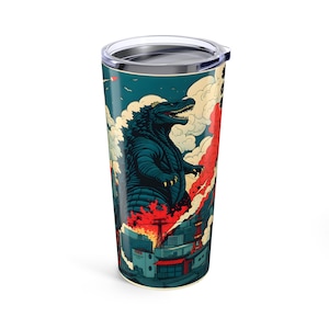 May include: A teal travel tumbler featuring a Godzilla illustration in a vintage Japanese art style. The design includes a teal Godzilla figure, red flames, and a cityscape. The tumbler has a silver lid and a white base.