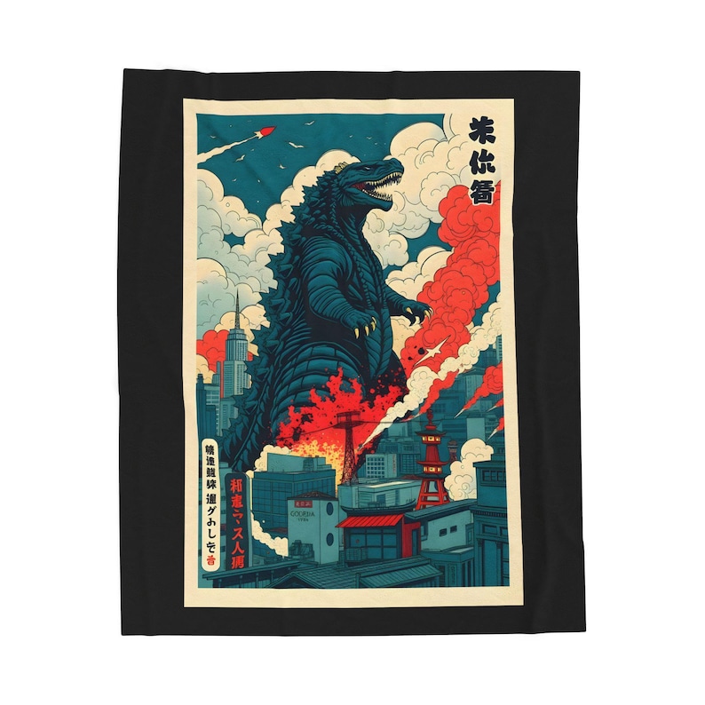 A black blanket featuring a Godzilla-themed design. The artwork depicts Godzilla in a city setting with red and blue hues, reminiscent of a vintage Japanese poster. The blanket is rectangular and placed on a bed.