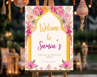 May include: A welcome sign with a floral design and a gold archway. The sign says "Welcome to Samia's Dholki & Mehendi Night 27.09.2024".