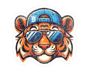 May include: A sticker featuring a stylized tiger head wearing sunglasses and a blue baseball cap. The tiger has orange and black stripes, with a distressed, vintage effect. The cap has a white "D" logo.