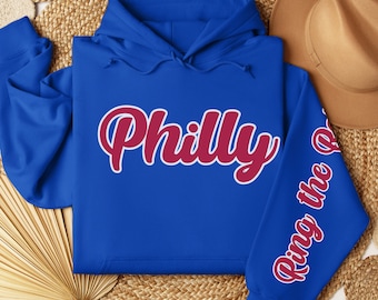 May include: A royal blue hoodie with a red "Philly" graphic on the front and "Ring the Bell" on the sleeve.