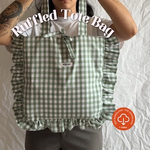 May include: A green and white gingham patterned tote bag with ruffled edges. The bag has a bow closure and the text "Ruffled Tote Bag" is displayed at the top. The brand name "mimo" is visible on a small label.