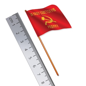May include: A red flag with the text "За нашу советскую родину" (For our Soviet Motherland) in yellow letters and a hammer and sickle symbol. The flag is attached to a wooden stick and is being measured with a ruler.