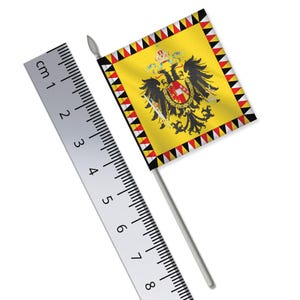 Puede incluir: Una bandera amarilla con un águila negra y un escudo rojo con una cruz blanca. La bandera tiene un borde negro y blanco con un patrón de triángulo repetitivo. La bandera está unida a un palo blanco.