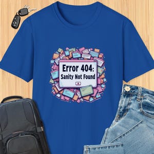 May include: A royal blue t-shirt with a graphic of a computer screen displaying the text "Error 404: Sanity Not Found". The graphic is surrounded by colorful icons.