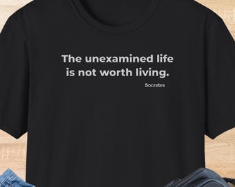 May include: Black t-shirt with the quote "The unexamined life is not worth living" by Socrates in white text. The word "BLACK" is printed at the bottom of the shirt.