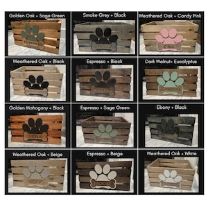 May include: Twelve wooden dog crates with different paint colors and paw print designs. Each crate has a name tag with a dog's name on it. The crates are arranged in a grid of four rows and three columns.