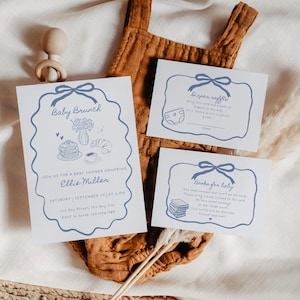 May include: Baby shower invitation set with a blue bow design. The invitation includes the text "Baby Brunch" and details for Ellie Miller's baby shower. Also included are cards for a diaper raffle and books for baby.