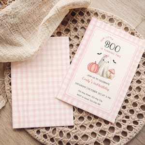 May include: Pink gingham-patterned birthday invitation with the text "OUR LITTLE BOO IS TURNING TWO." The invitation features a ghost, pumpkin, and mushroom illustration. Includes event details: date, time, and RSVP information.