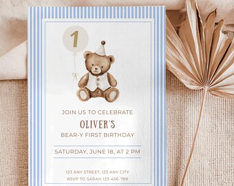 May include: A baby's first birthday invitation with a teddy bear illustration. The invitation features a light blue striped border, a teddy bear wearing a party hat, and the text "Oliver's Bear-y First Birthday".