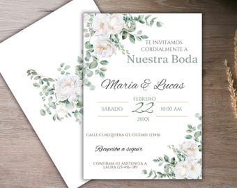 Puede incluir: Invitación de boda blanca con follaje verde y flores blancas. La invitación dice "Te Invitamos Cordialmente a Nuestra Boda Maria & Lucas Febrero 22 10:00 AM 20XX Calle Cualquiera 123, Ciudad, 123456 Recepcion a seguir Confirma su asistencia a: Laura 123-456-789"