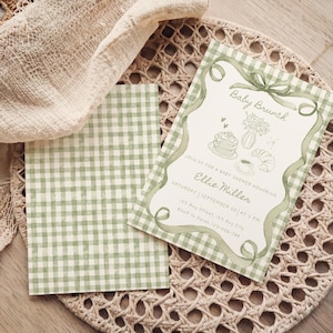 May include: A baby brunch invitation with a green gingham pattern and watercolor illustrations. The invitation features the text "Baby Brunch" and details for Ellie Miller's baby shower, including the date, time, and RSVP information.