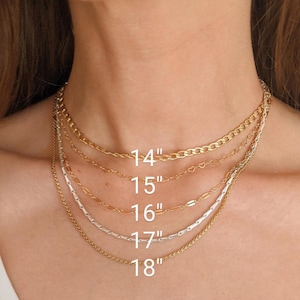 May include: A selection of gold and silver necklaces of varying styles and lengths. The necklaces range from 14 inches to 18 inches in length. The image shows the necklaces around a person's neck, with the lengths labeled in white text.