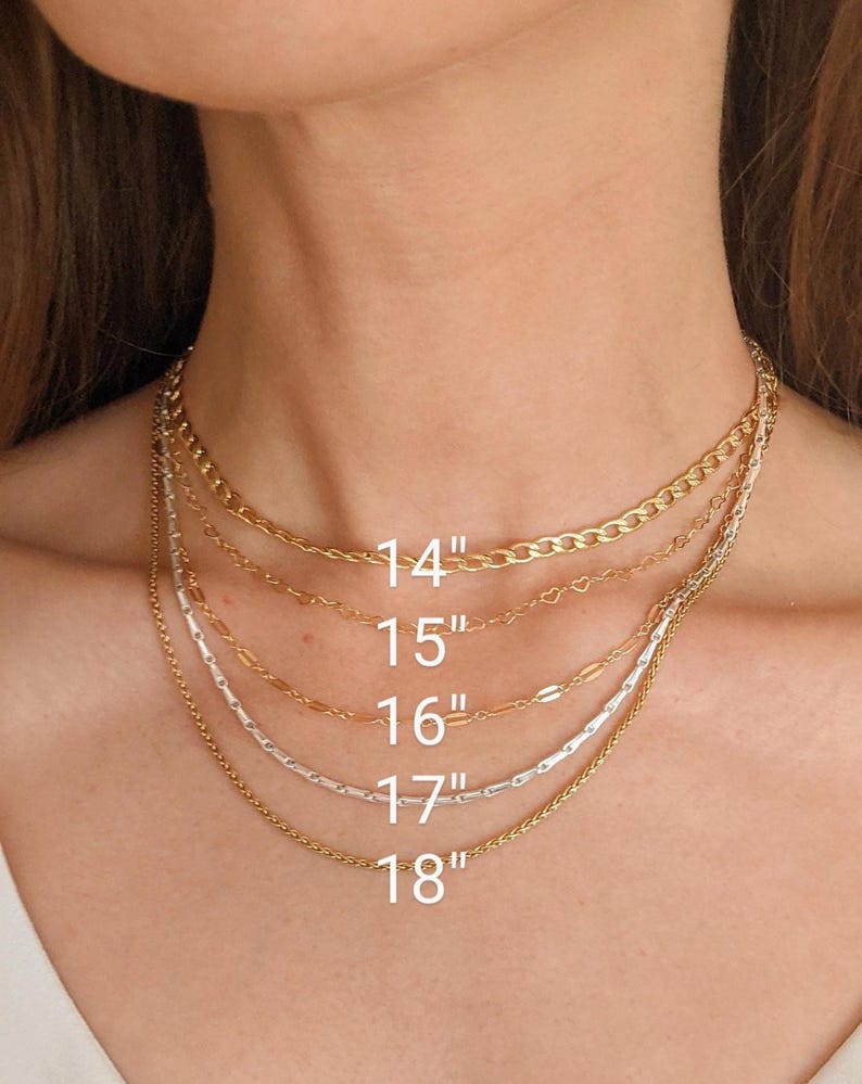 May include: A selection of gold and silver necklaces of varying styles and lengths. The necklaces range from 14 inches to 18 inches in length. The image shows the necklaces around a person's neck, with the lengths labeled in white text.