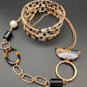 Set di gioielli Y2K: bracciale e collana vintage in oro con stampa leopardata.