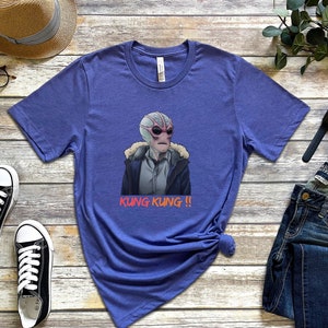 May include: A purple t-shirt with a graphic of an alien wearing a jacket and the text "Kung Kung!!" printed on it.